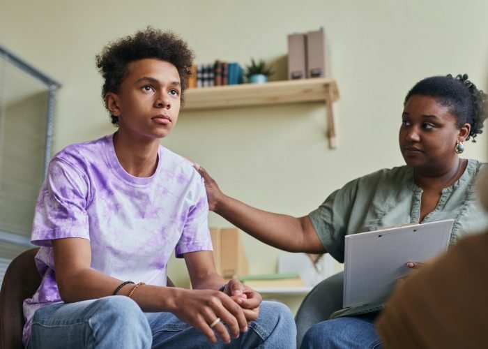 Teenage boy at group therapy session