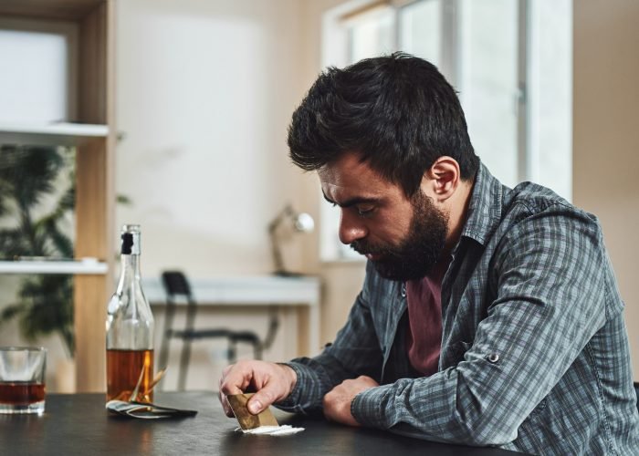 The drug addict is his own enemy slowly killing himself using drugs as a weapon. Man preparing a